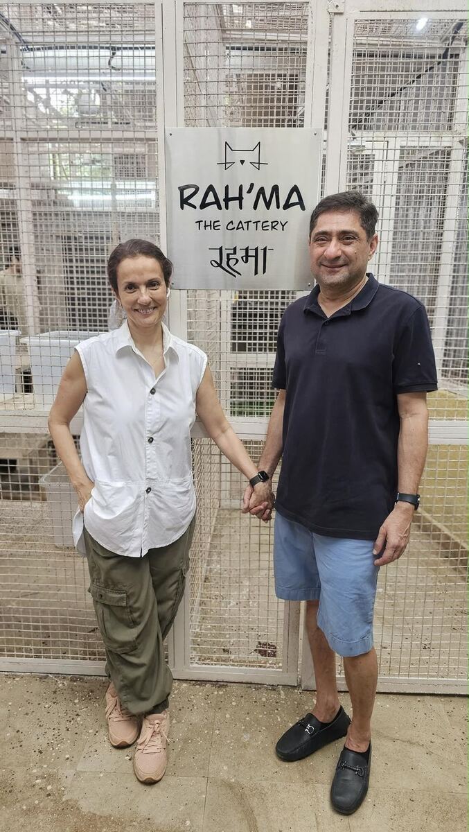 Sausan and Salim Govani standing beside the 'Rah'ma The Cattery' sign at the Malad shelter